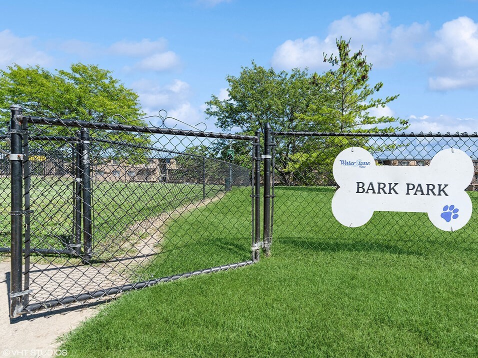 a dog park with a fence at apartment complex
