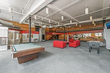 game room with a pool table and foosball