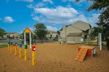 a playground in a neighborhood with a house in the background