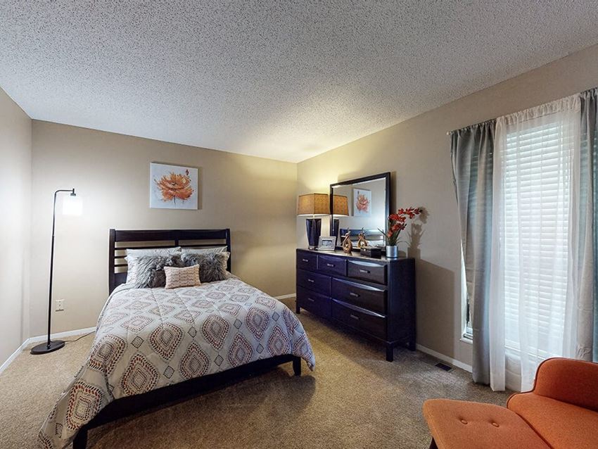 a bedroom with a bed and a dresser