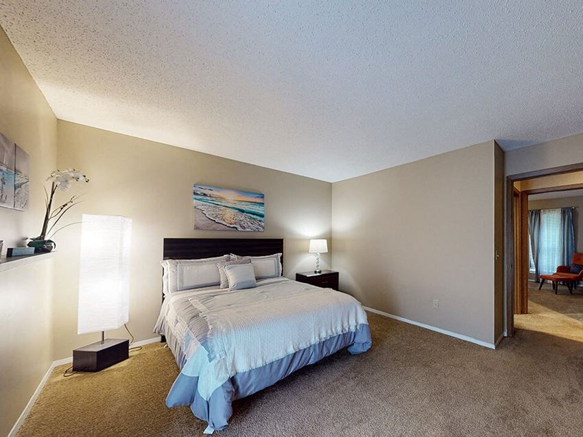 a bedroom with a bed and two night stands