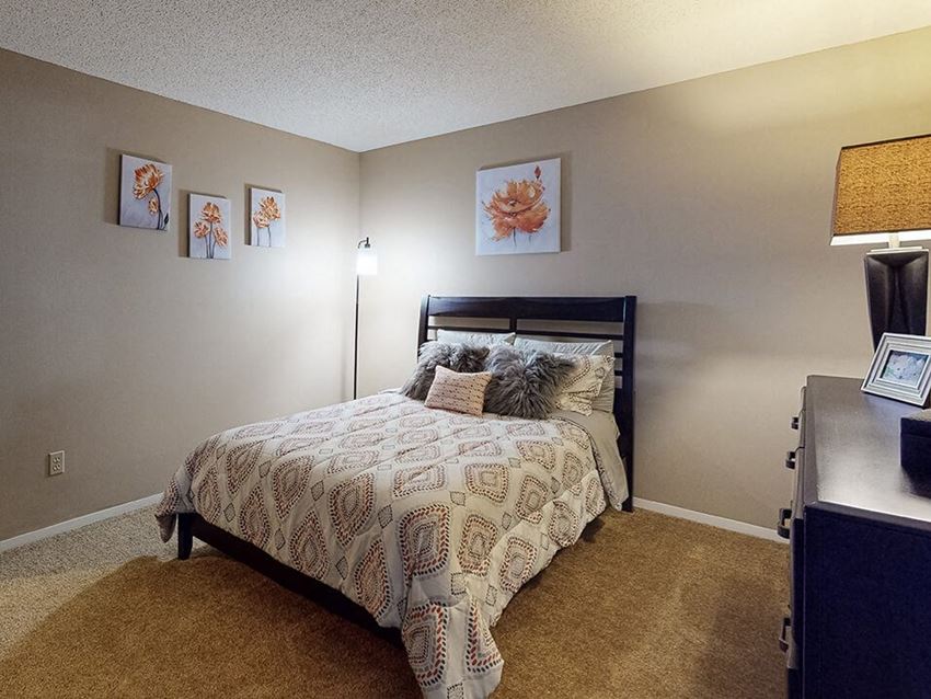 a bedroom with a bed and a desk