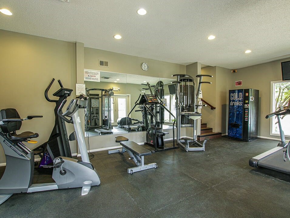 a gym with treadmills and other exercise equipment