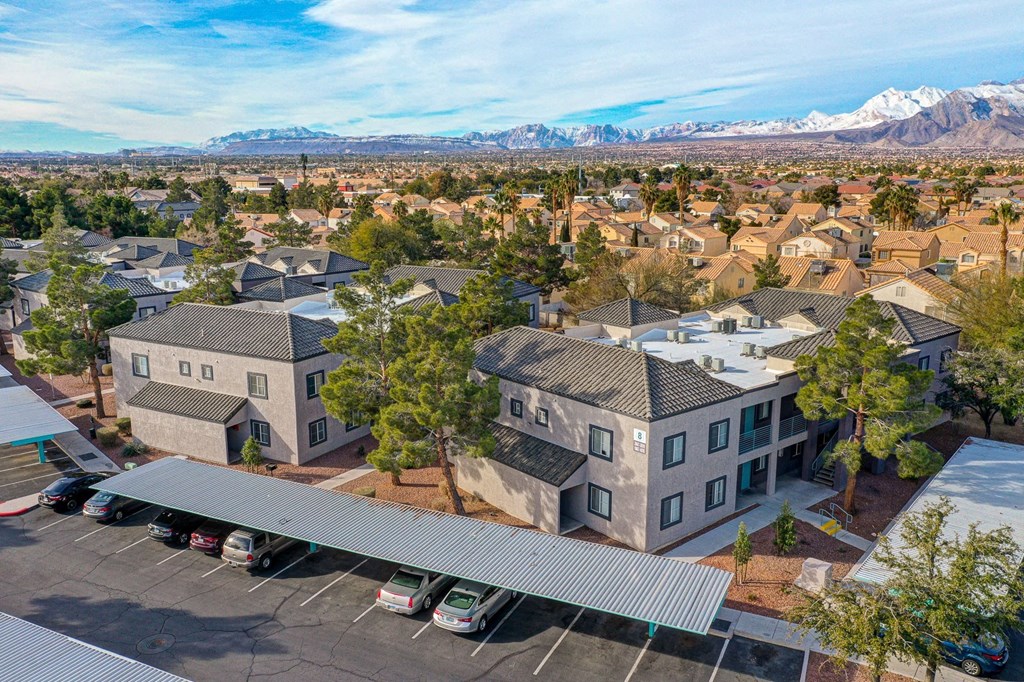an aerial view of an apartment community with mountains in the background