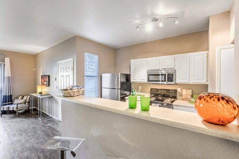 A kitchen with a white counter and a bowl on it.