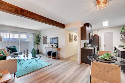 A modern open plan living and kitchen area with a dining table and chairs.
