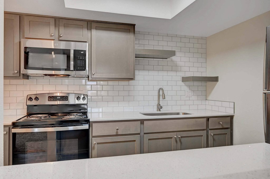A modern kitchen with stainless steel appliances at Solstice Apartment Homes, Las Vegas, 89108