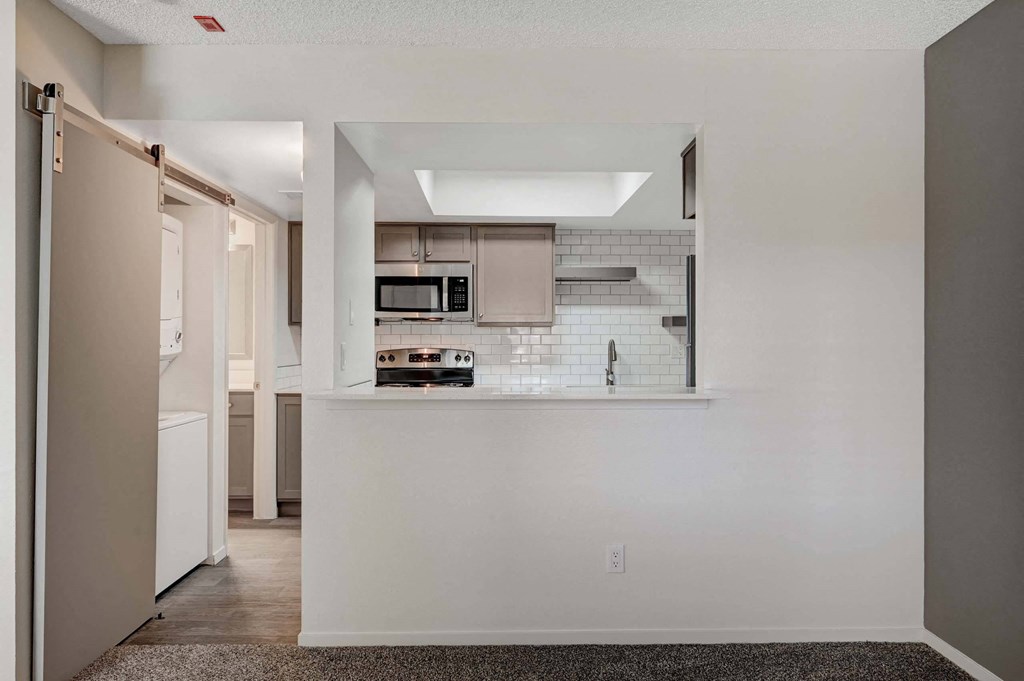 A kitchen with white cabinets and a white countertop. at Solstice Apartment Homes, Las Vegas