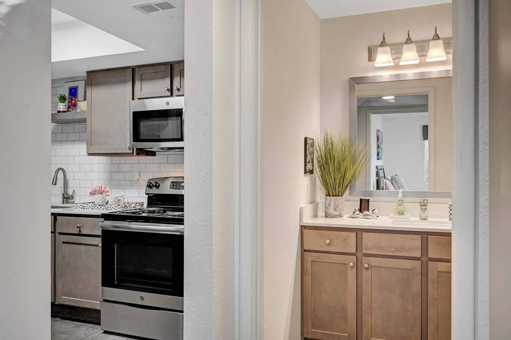 A kitchen with a stove top oven and a microwave above it. at Solstice Apartment Homes, Las Vegas, 89108