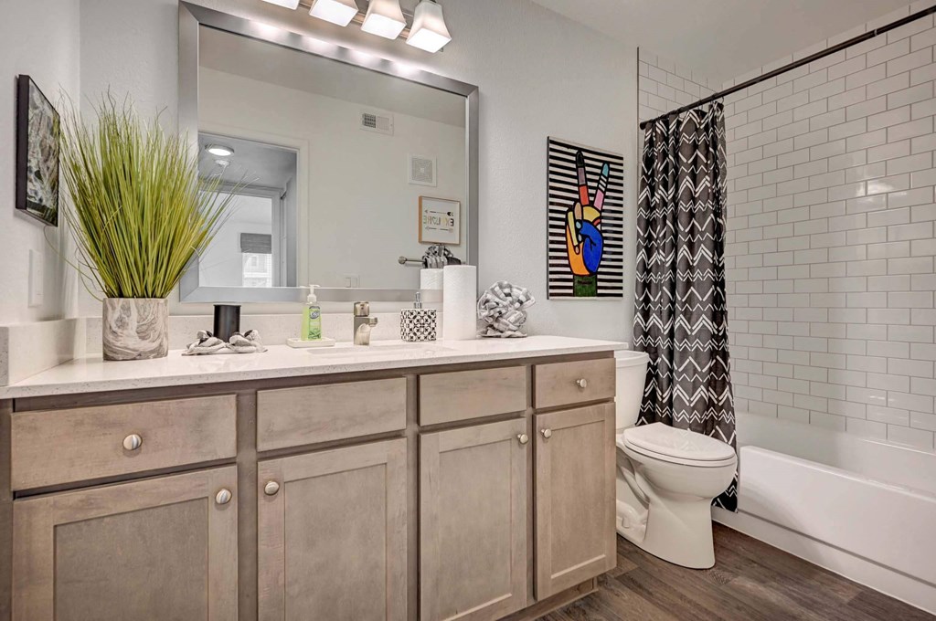 A bathroom with a white toilet and a white sink. at Solstice Apartment Homes, Nevada, 89108