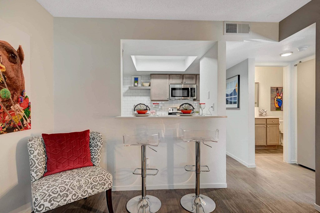 A kitchen with a bar stool  at Solstice Apartment Homes, Las Vegas, NV