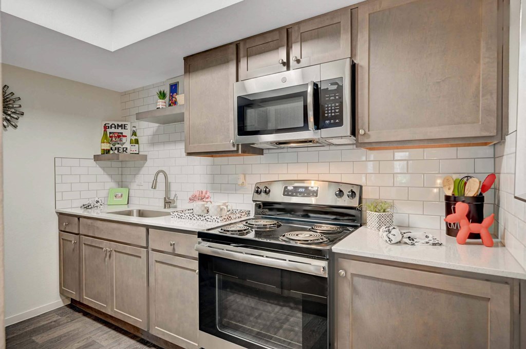 A modern kitchen with a stove, oven, and microwave. at Solstice Apartment Homes, Las Vegas, NV