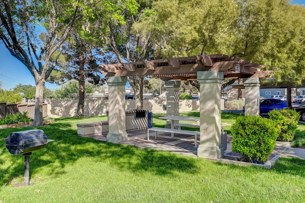 A park bench under a pergola in a sunny day. at Solstice Apartment Homes, Las Vegas, 89108