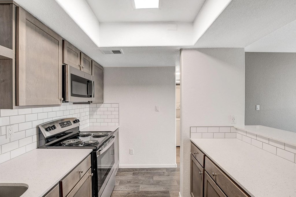 A kitchen with a stove, microwave, and oven. at The 95 Apartments, Las Vegas, NV
