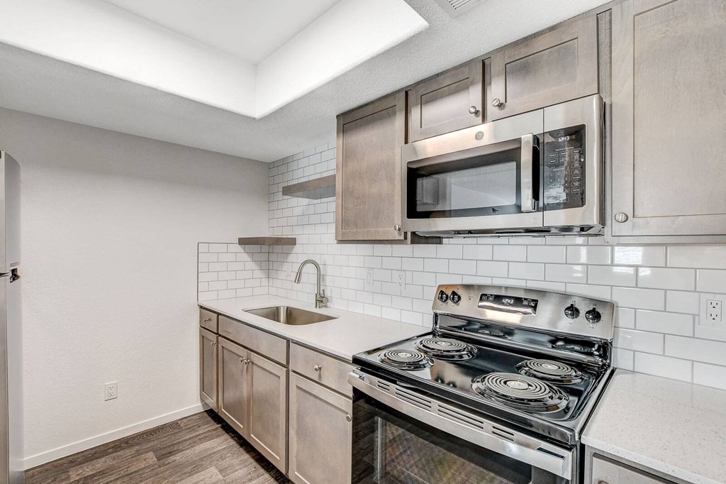 A modern kitchen with a stainless steel oven and microwave above the stove. at The 95 Apartments, Las Vegas, 89129