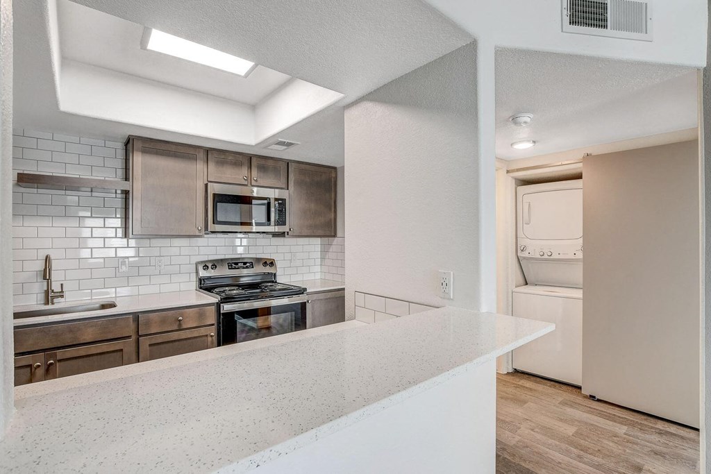 A modern kitchen with a white countertop and a stainless steel oven. at The 95 Apartments, Las Vegas, NV