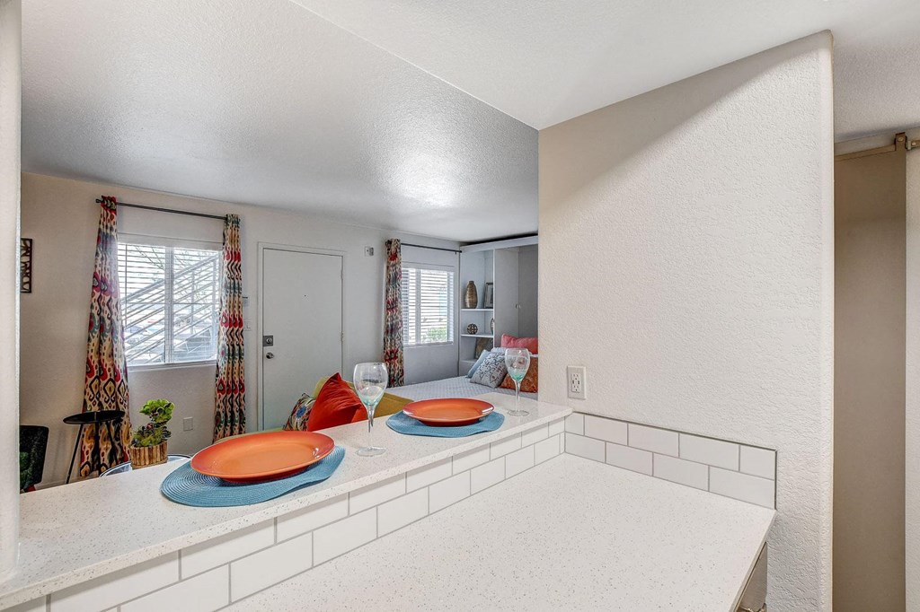 A kitchen with a white counter and a window with curtains. at The 95 Apartments, Las Vegas, Nevada