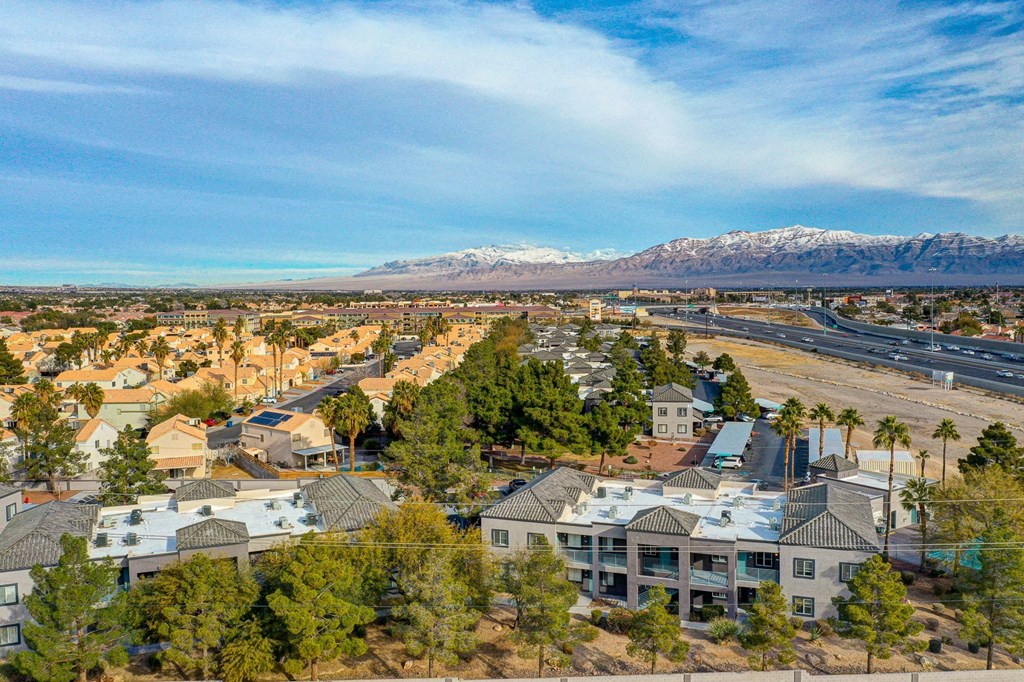 an aerial view of a city with mountains in the background