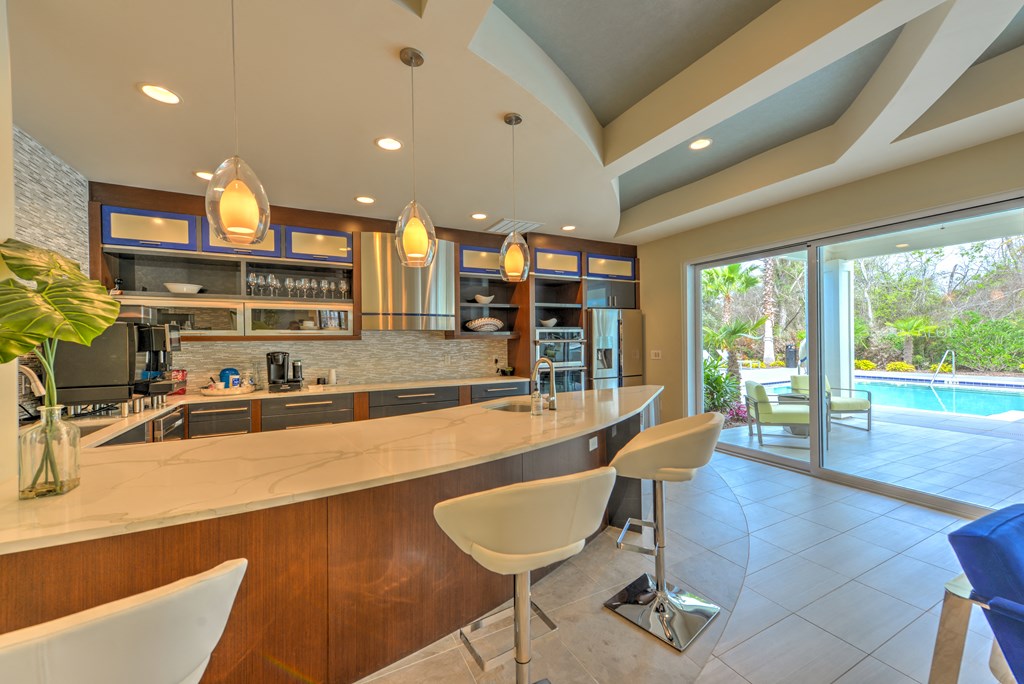 a large kitchen with a bar and a pool