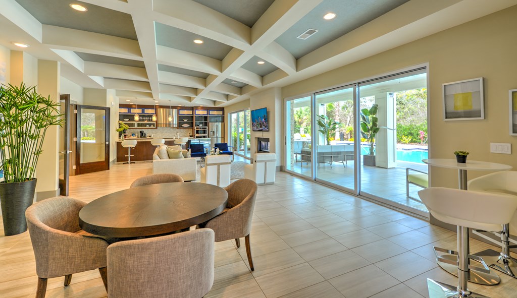 a dining room with a table and chairs and sliding glass doors