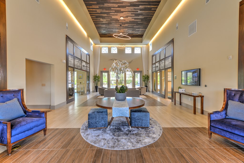 a lobby with blue chairs and a round table
