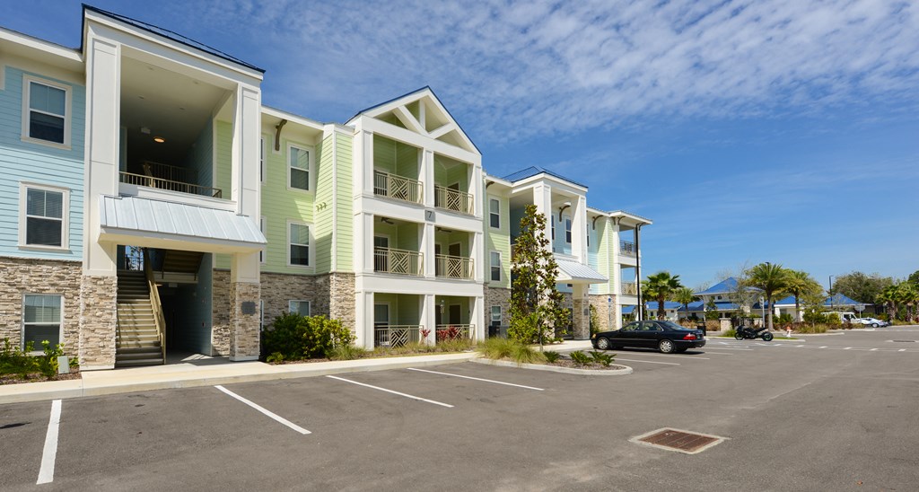 an empty parking lot in front of an apartment building