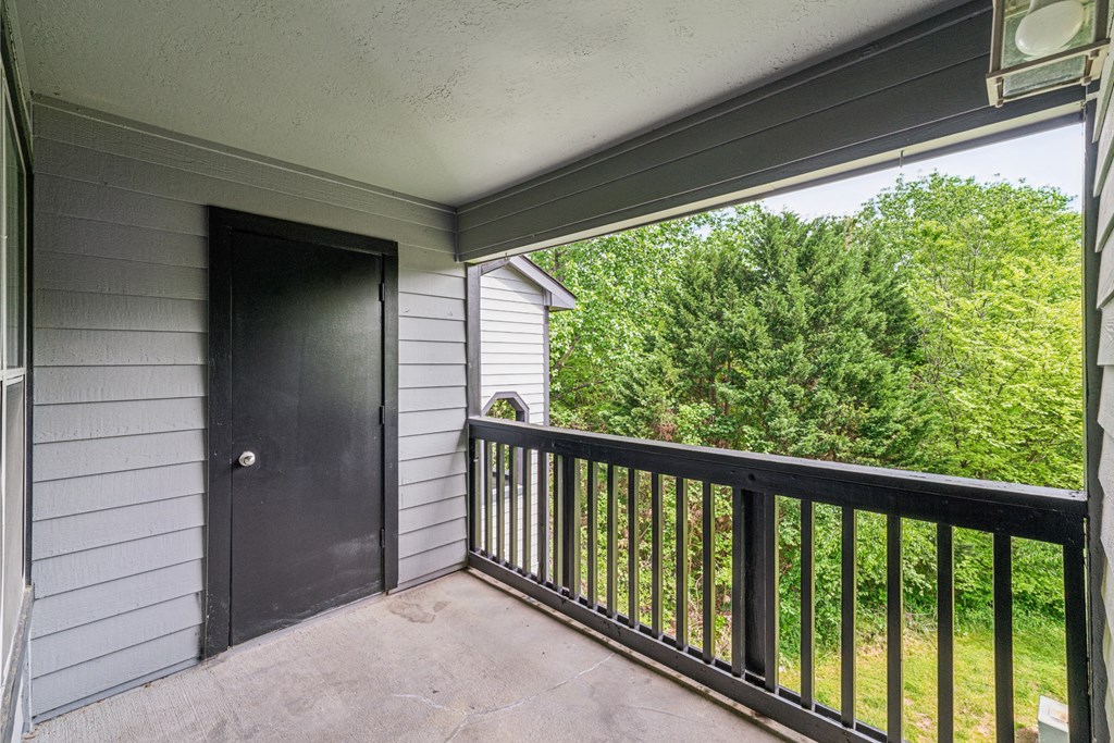 the view from the balcony of a home with a black door