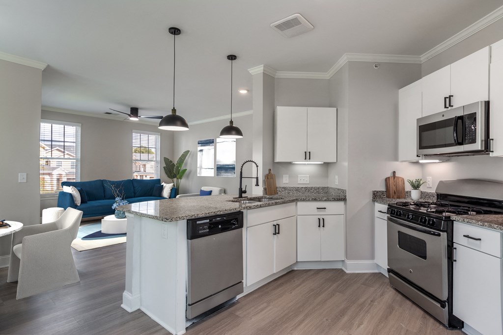 A modern kitchen with a large island and stainless steel appliances.