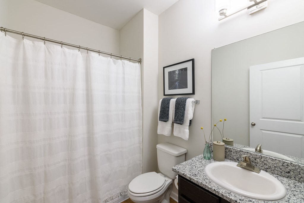 A toilet sits next to a white sink in a bathroom.