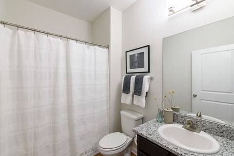 A toilet sits next to a white sink in a bathroom.