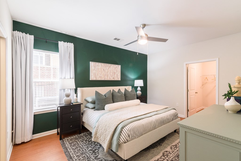 Bedroom with nightstand, and ceiling fan.