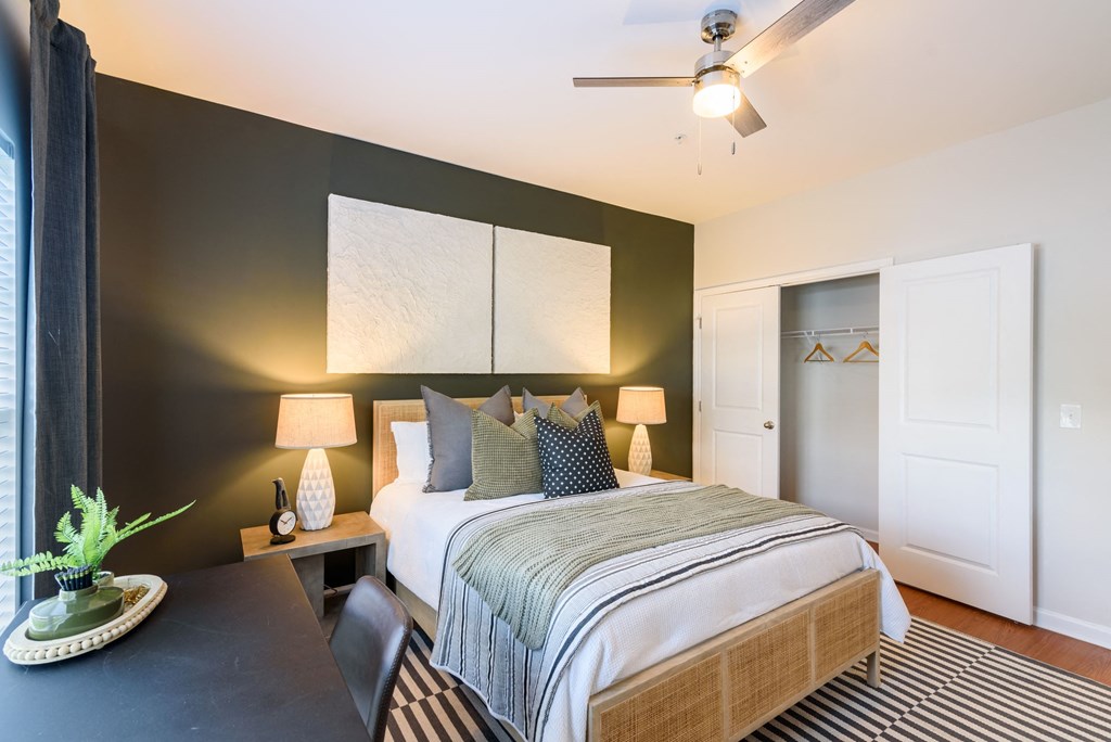 a bedroom with a bed and a ceiling fan