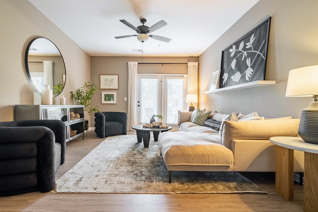 a living room with a couch and a ceiling fan
