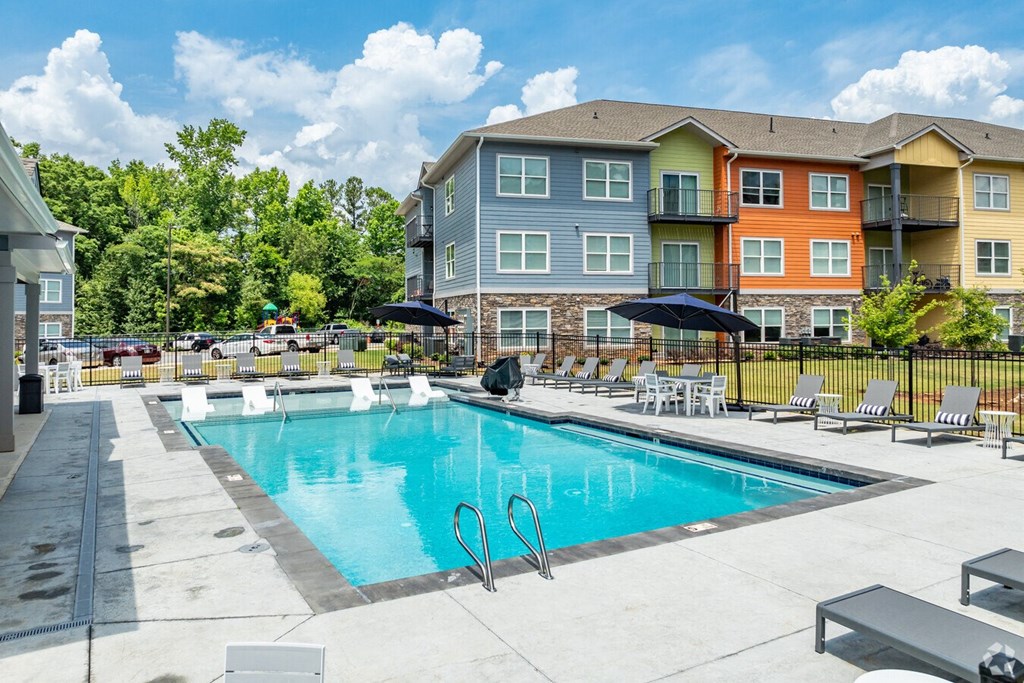 our apartments have a resort style pool with chairs and umbrellas