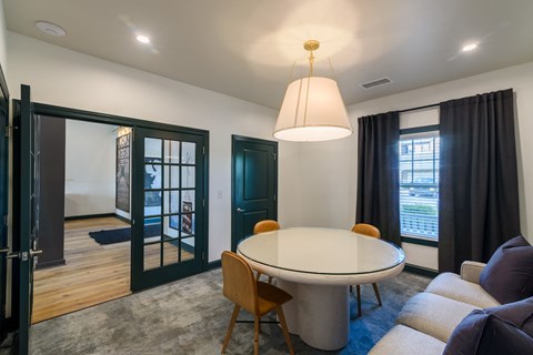 a dining area with a table and chairs and a living room with a couch