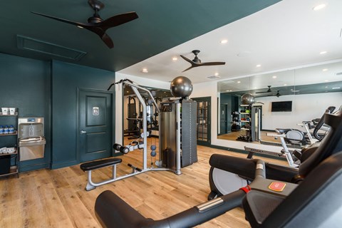 a home gym with exercise equipment and a mirror