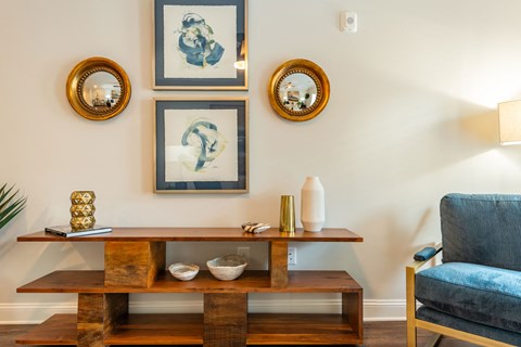 a living room with a table and chairs and pictures on the wall