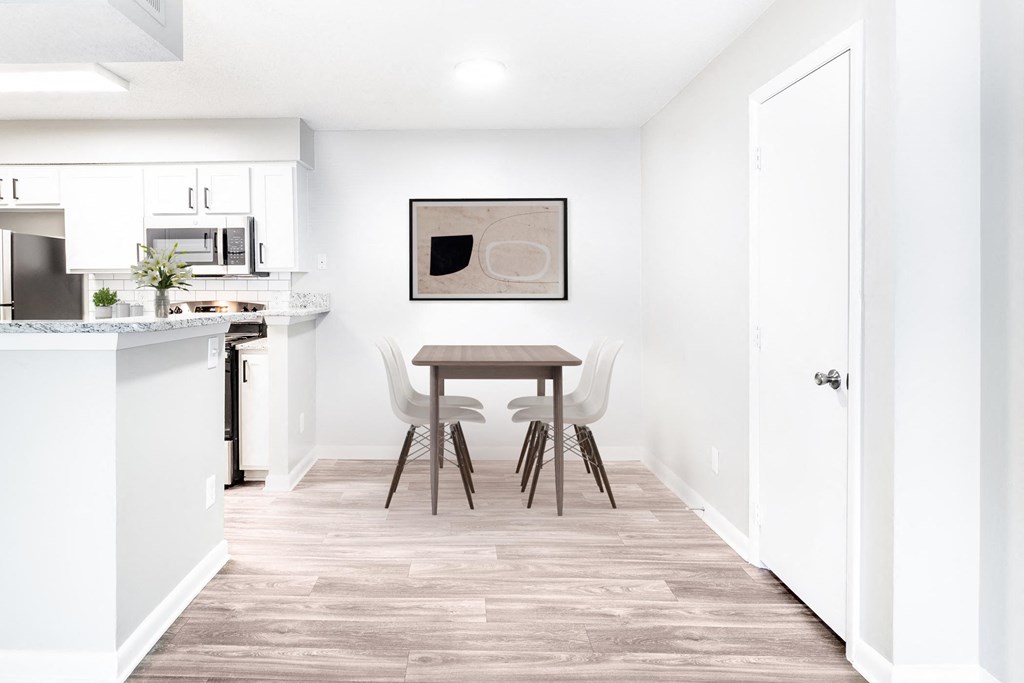 a dining room with a table and chairs and a kitchen