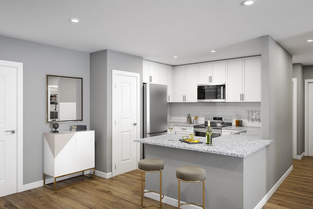 a kitchen with white cabinets and a marble counter top