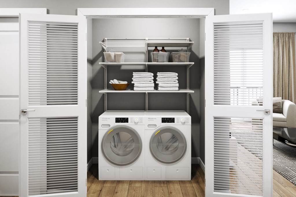 a white laundry room with a washer and a dryer