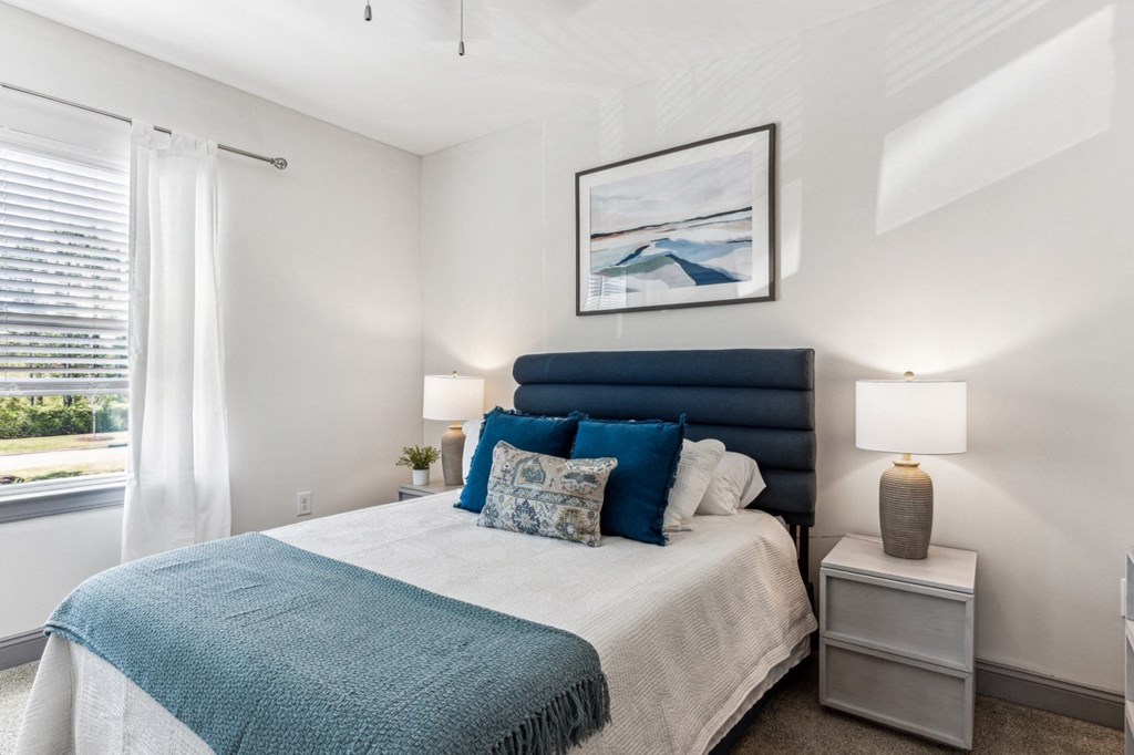 a bedroom with a large bed and a window