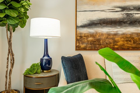 a living room with a couch and a lamp