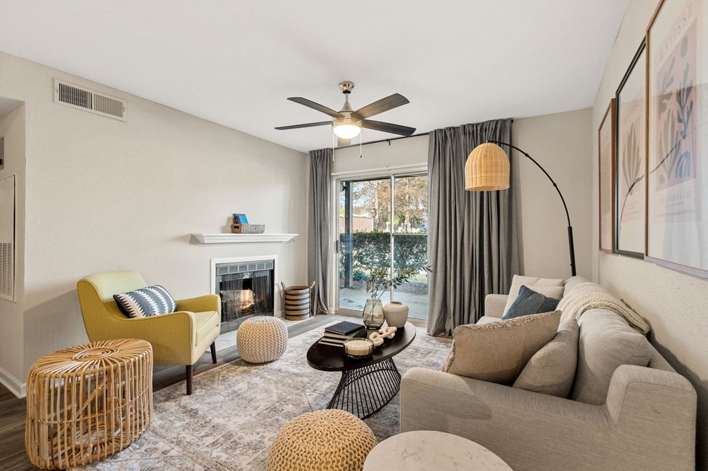 a living room with couches and chairs and a fireplace