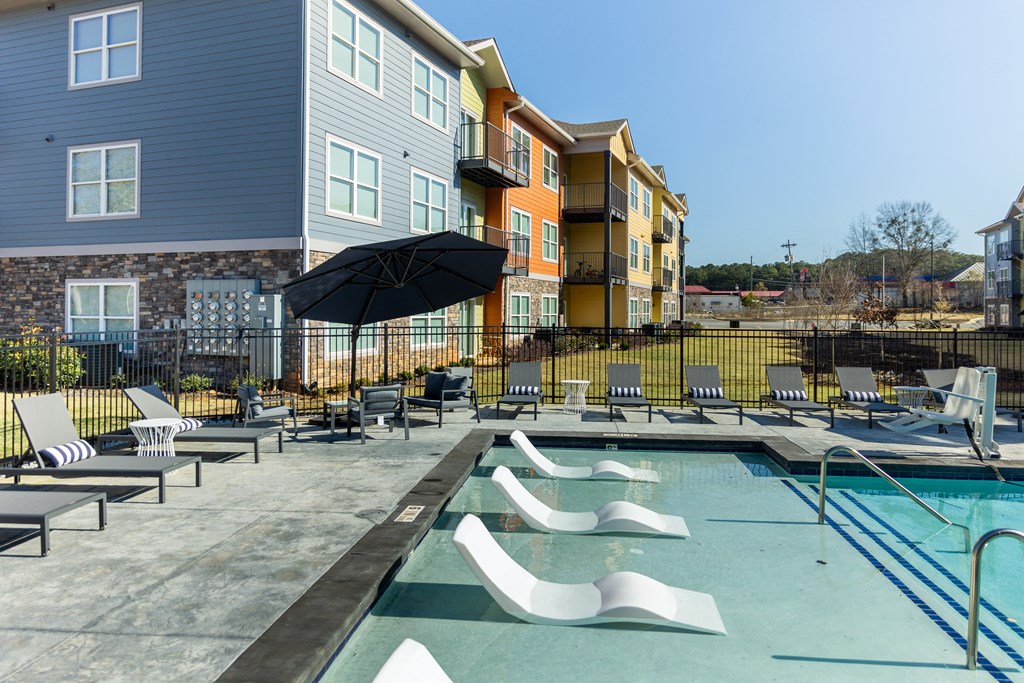 our apartments have a large pool with lounge chairs and umbrellas