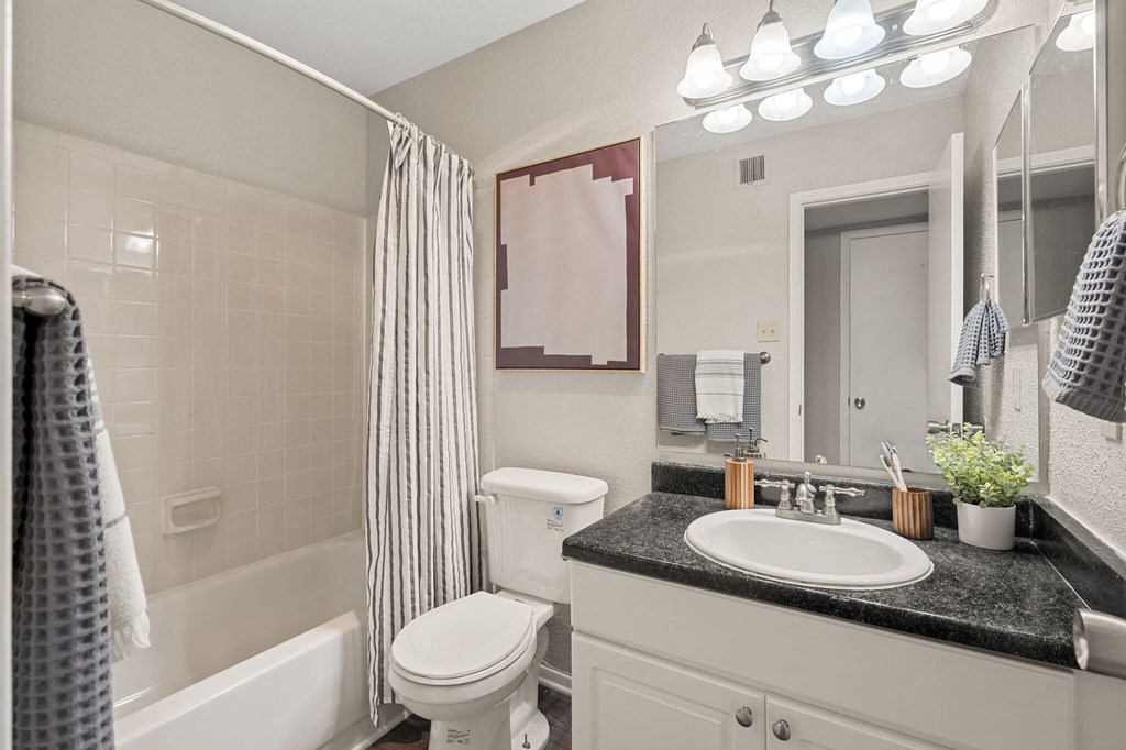 a white bathroom with a white toilet and a sink