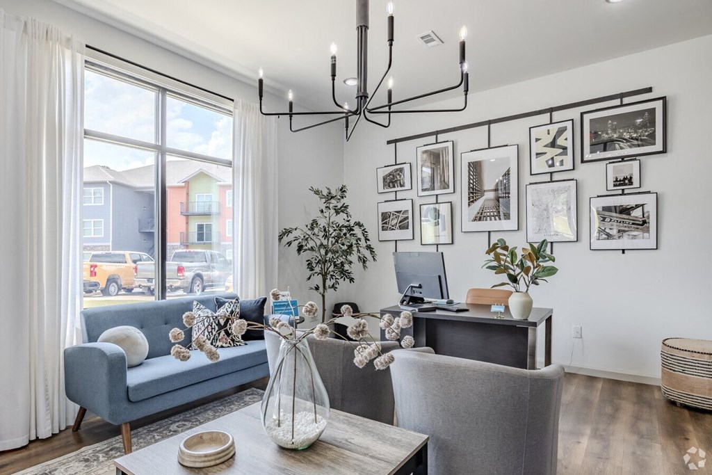 a living room with a couch and a desk and a window