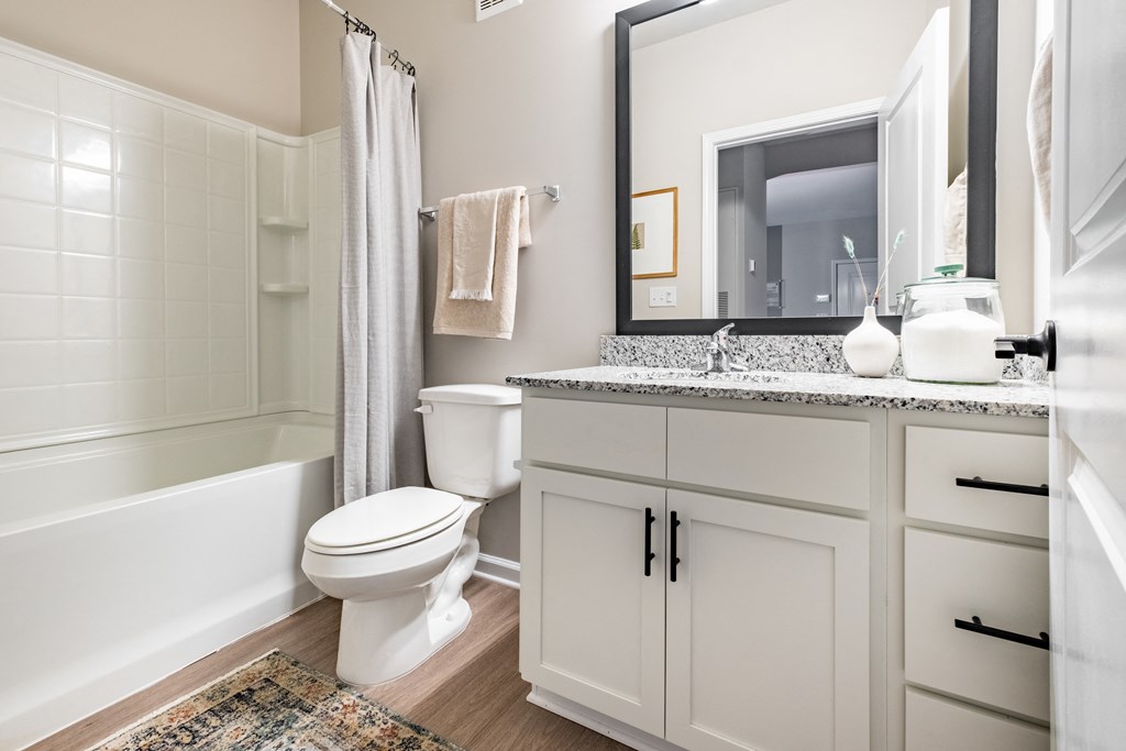 a bathroom with a toilet and a shower and a sink