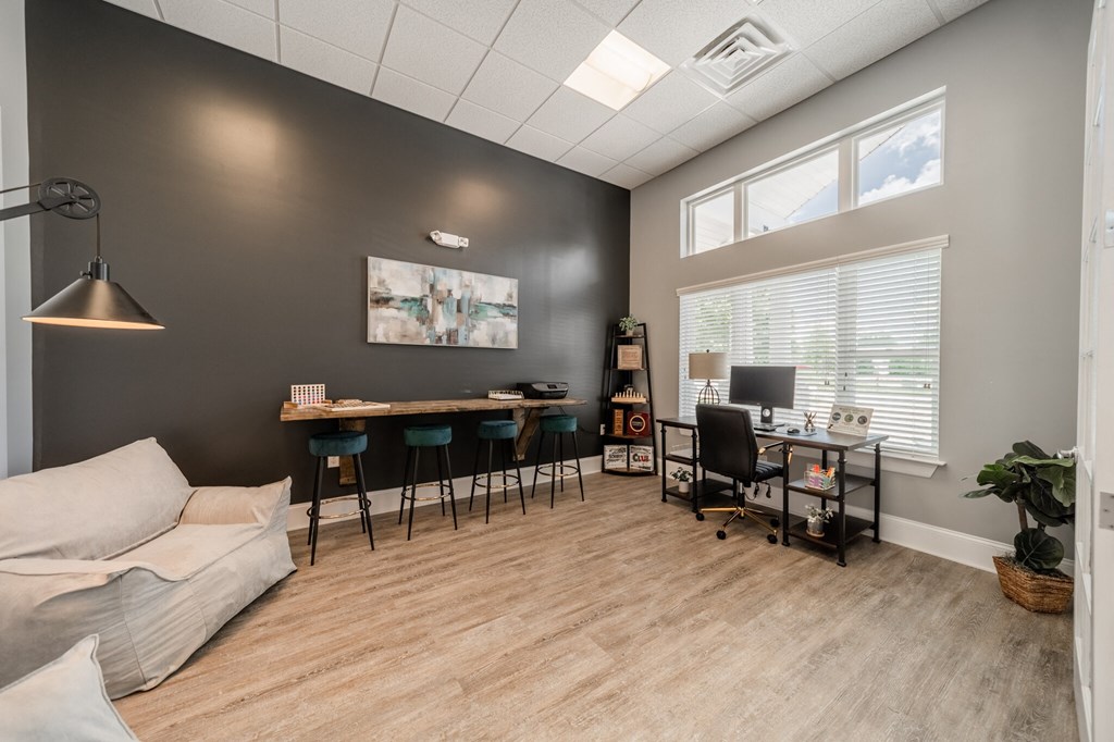 A room with a grey wall and a white couch.
