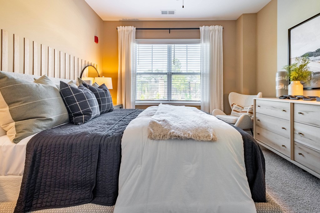 a bedroom with a bed and a window