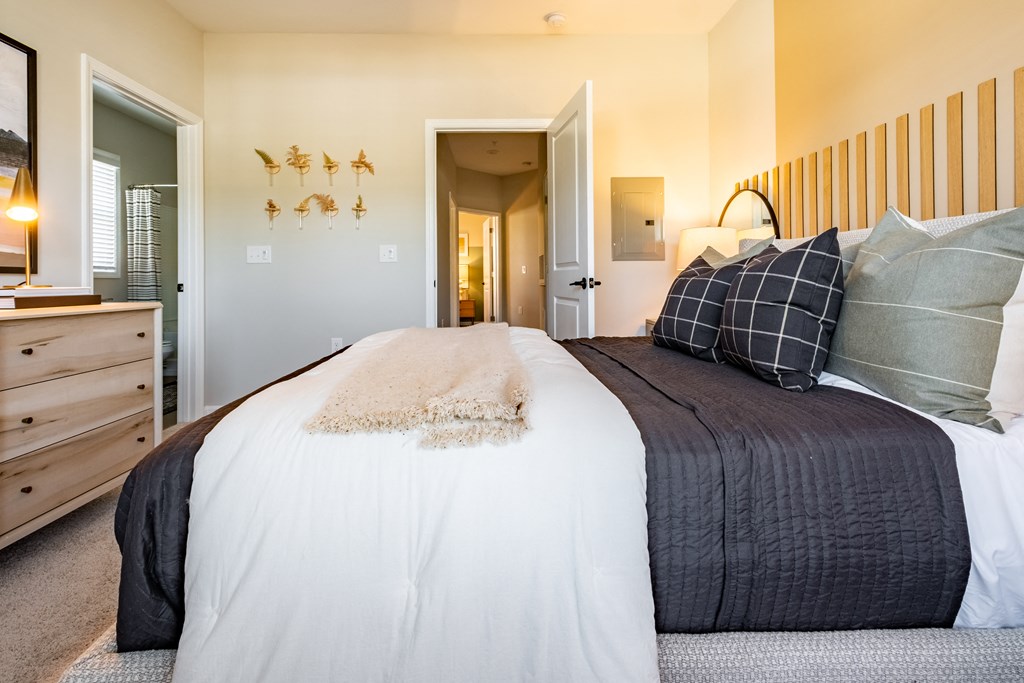 a bedroom with a large bed and a door to a hallway